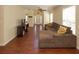 Spacious living room with hardwood floors, a large sectional sofa, and ample natural light at 2429 Scholar Ln, North Charleston, SC 29406