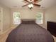 Bright bedroom with two windows, ceiling fan, and dresser at 2429 Scholar Ln, North Charleston, SC 29406