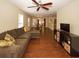 Open living room with hardwood floors, sectional sofa, and views into dining area at 2429 Scholar Ln, North Charleston, SC 29406