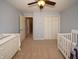Baby's room with crib, dresser, and ceiling fan at 2429 Scholar Ln, North Charleston, SC 29406