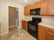 Kitchen with black appliances and light wood cabinets at 2429 Scholar Ln, North Charleston, SC 29406