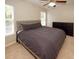 King-size bed in spacious bedroom with two windows at 2429 Scholar Ln, North Charleston, SC 29406