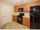 Kitchen with black appliances and light wood cabinets at 2429 Scholar Ln, North Charleston, SC 29406