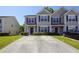 Tan two-story home with dark shutters and landscaping at 2429 Scholar Ln, North Charleston, SC 29406