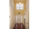 Bright two-story entryway with hardwood floors and a view to a half bath at 2429 Scholar Ln, North Charleston, SC 29406