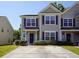 Tan two-story home with dark-colored doors and landscaping at 2429 Scholar Ln, North Charleston, SC 29406