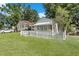 Yellow cottage with white picket fence and lush green lawn at 1927 Iris St, North Charleston, SC 29405