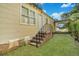 Small backyard with brick steps leading to a back door and covered carport at 1927 Iris St, North Charleston, SC 29405