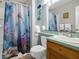 Bathroom with shower/tub combo, wooden vanity, and ocean-themed decor at 144 Palmetto Blvd, Edisto Island, SC 29438