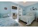 Bedroom with ocean view, twin and queen beds, and access to deck at 144 Palmetto Blvd, Edisto Island, SC 29438