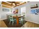Dining area with wooden table, light-green chairs, and beach decor at 144 Palmetto Blvd, Edisto Island, SC 29438
