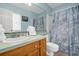 Clean bathroom with shower/tub combo, vanity, and beach-themed decor at 144 Palmetto Blvd, Edisto Island, SC 29438