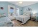 Bedroom with ocean view, twin and queen beds, and direct access to deck at 144 Palmetto Blvd, Edisto Island, SC 29438