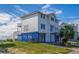 Two-story beach home with blue accents and elevated foundation at 144 Palmetto Blvd, Edisto Island, SC 29438