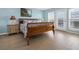Main bedroom with wooden sleigh bed and access to balcony at 144 Palmetto Blvd, Edisto Island, SC 29438