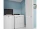 Well-lit laundry room complete with washer, dryer, and built-in storage at 144 Palmetto Blvd, Edisto Island, SC 29438