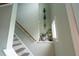 Staircase with gray steps, wooden railing, and unique wall decor at 144 Palmetto Blvd, Edisto Island, SC 29438