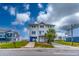 Two-story beach home with blue accents and elevated foundation at 144 Palmetto Blvd, Edisto Island, SC 29438