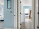 Light blue hallway with white trim and doors leading to bedrooms at 144 Palmetto Blvd, Edisto Island, SC 29438