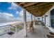 Deck with ocean views and seating area for outdoor enjoyment at 144 Palmetto Blvd, Edisto Island, SC 29438