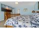 King bedroom with coastal bedding and large TV at 144 Palmetto Blvd, Edisto Island, SC 29438