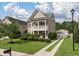 Tan two-story house with a detached garage and driveway at 1510 Thoroughbred Blvd, Johns Island, SC 29455