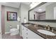 Double vanity bathroom with granite countertop and large mirror at 9002 Palmetto Dr # 512, Isle of Palms, SC 29451
