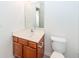 Simple bathroom with toilet and a vanity with wood cabinets at 1151 Saint Pauls Parrish Ln, Johns Island, SC 29455