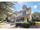 Tan two-story townhome with two-car garage and manicured landscaping at 1151 Saint Pauls Parrish Ln, Johns Island, SC 29455