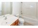 Clean bathroom with tub, toilet, and vanity with wood cabinets at 1151 Saint Pauls Parrish Ln, Johns Island, SC 29455