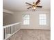 Bright loft area with two windows and a ceiling fan at 1151 Saint Pauls Parrish Ln, Johns Island, SC 29455