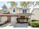 Tan two-story townhome with two-car garage and manicured landscaping at 1151 Saint Pauls Parrish Ln, Johns Island, SC 29455