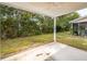 Concrete patio overlooks backyard with lush trees and grass at 1151 Saint Pauls Parrish Ln, Johns Island, SC 29455