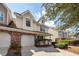 Tan two-story townhome with two-car garage and manicured landscaping at 1151 Saint Pauls Parrish Ln, Johns Island, SC 29455