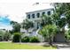 Two story beach home with a large front porch and attached garage at 3002 Palmetto Blvd # 6, Edisto Beach, SC 29438