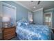 Bedroom with queen bed, light blue bedding, and hardwood floors at 3002 Palmetto Blvd # 6, Edisto Beach, SC 29438