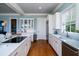 White kitchen with stainless steel appliances and hardwood floors at 3002 Palmetto Blvd # 6, Edisto Beach, SC 29438