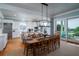 Large dining room with a wooden table and access to a deck at 3002 Palmetto Blvd # 6, Edisto Beach, SC 29438