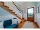 Bright entryway with hardwood floors, a staircase, and a blue bench at 3002 Palmetto Blvd # 6, Edisto Beach, SC 29438