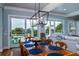 Bright dining area with wooden table and access to a deck overlooking ocean views at 3002 Palmetto Blvd # 6, Edisto Beach, SC 29438