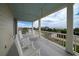 Spacious balcony with multiple rocking chairs and ocean views at 3002 Palmetto Blvd # 6, Edisto Beach, SC 29438