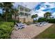 Two-story house with a refreshing pool and patio area with lounge chairs at 3002 Palmetto Blvd # 6, Edisto Beach, SC 29438