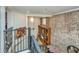 Loft overlooking living area with exposed brick wall at 377 King St # 101, Charleston, SC 29401