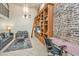 Spacious living area with exposed brick wall, built-in shelving, and home office at 377 King St # 101, Charleston, SC 29401