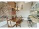Dining area with exposed brick wall and wooden table at 377 King St # 101, Charleston, SC 29401