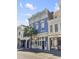 Three story commercial building with blue facade and street view at 377 King St # 101, Charleston, SC 29401
