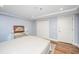 Simple bedroom with double doors and hardwood floors at 377 King St # 101, Charleston, SC 29401
