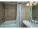 Clean bathroom with tub, shower, and pedestal sink at 377 King St # 101, Charleston, SC 29401