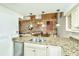 Modern kitchen with granite countertops and exposed brick wall at 377 King St # 101, Charleston, SC 29401