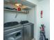 Well-equipped laundry room with washer, dryer, and storage shelves at 377 King St # 101, Charleston, SC 29401